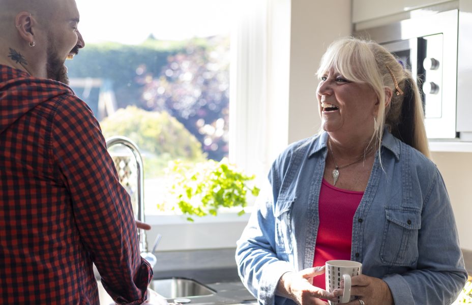 Mum and her son chatting in the kitchen